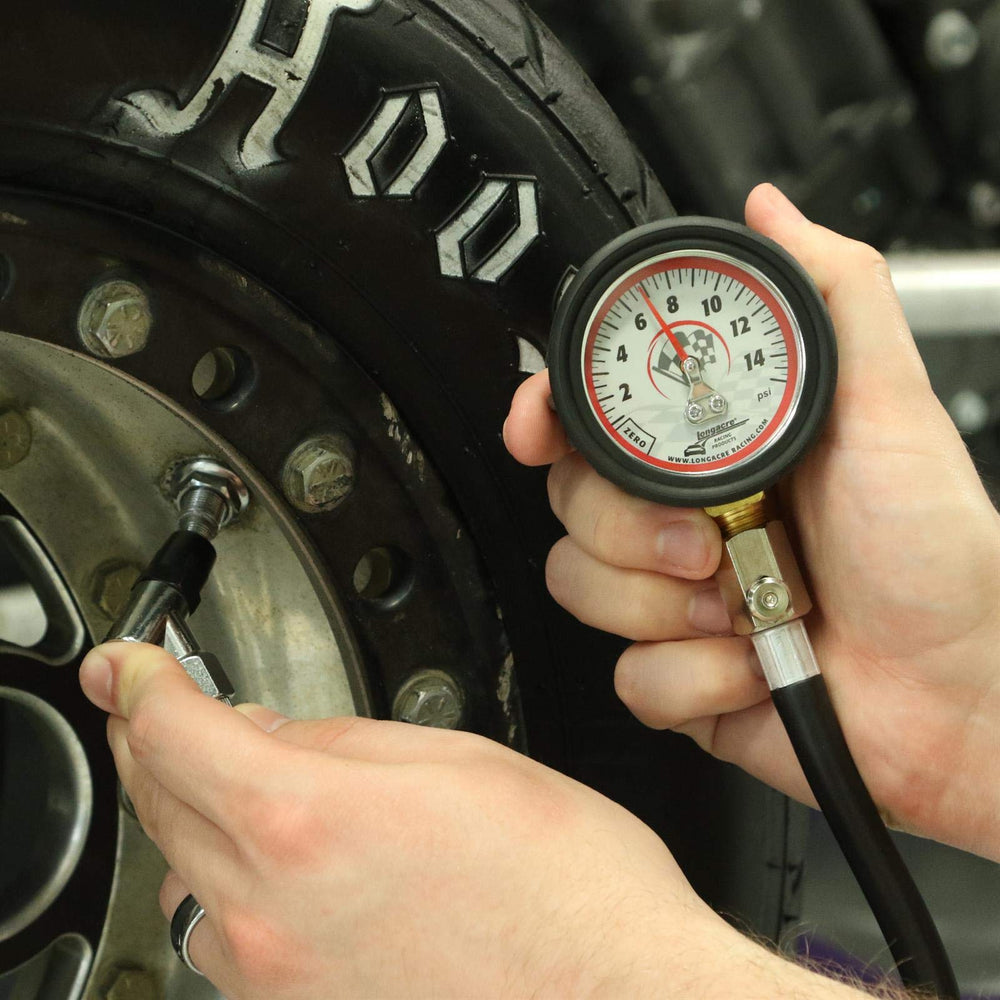 Longacre gauge attached to a race tire valve demonstrating accurate low-pressure tuning