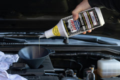 Lucas Oil 1 quart bottle beside a ruler for clear size and scale understanding