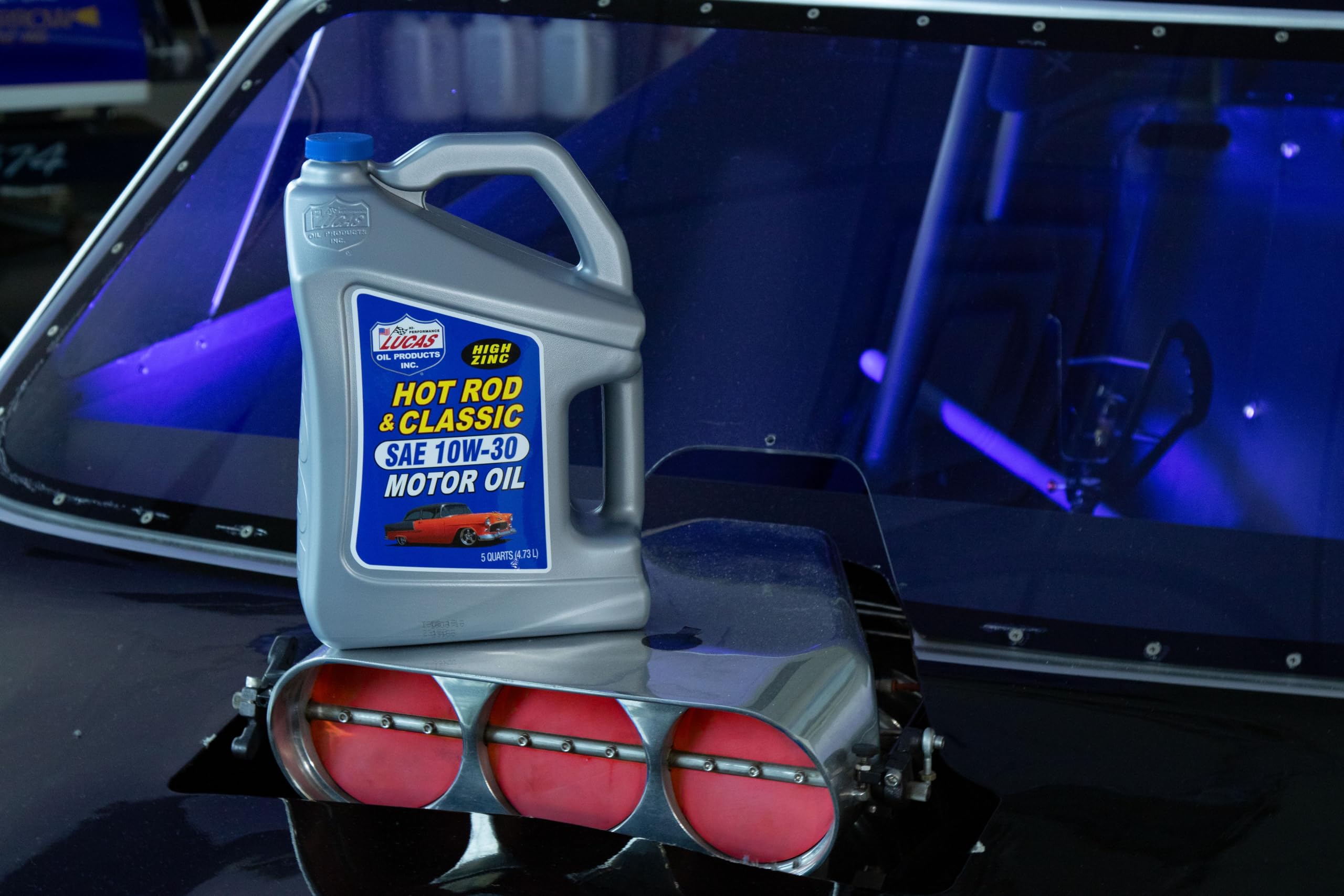 Lucas Oil five-quart next to a measuring cup showing scale