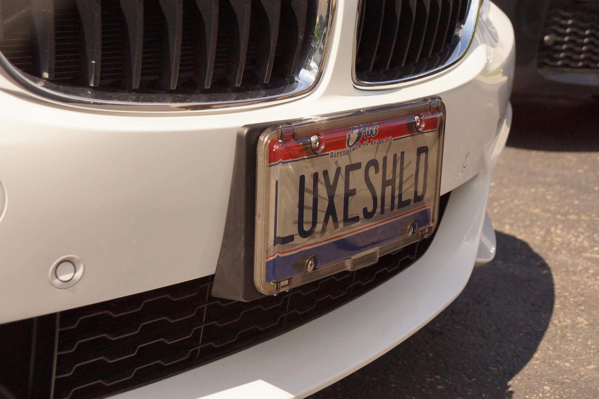 Luxe Shield lifestyle driveway shot adding stylish vehicle protection
