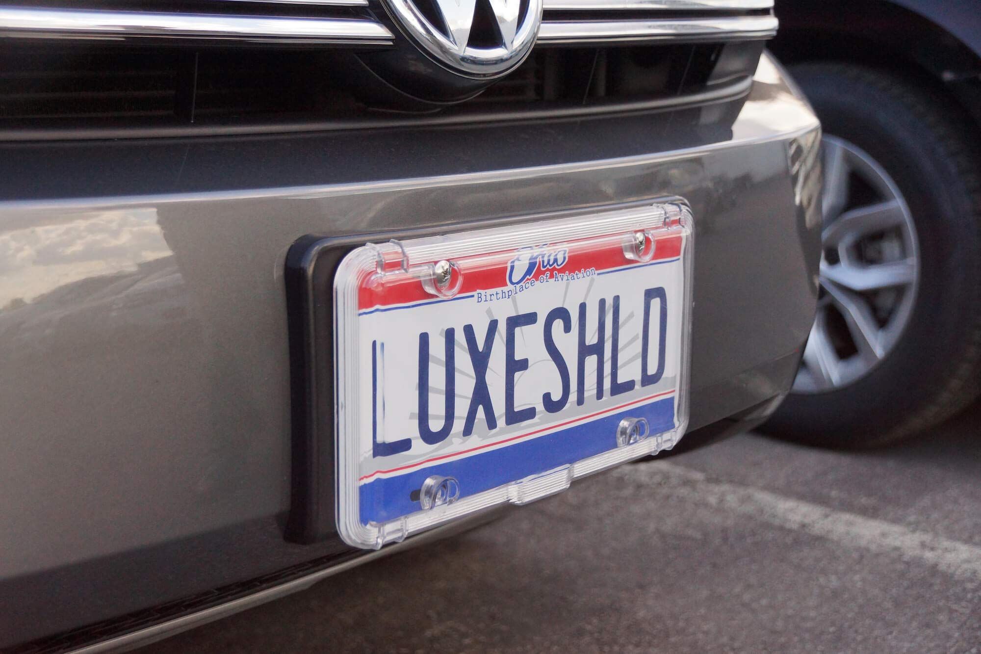 Luxe Shield on a car in rainy conditions protecting plate from water damage