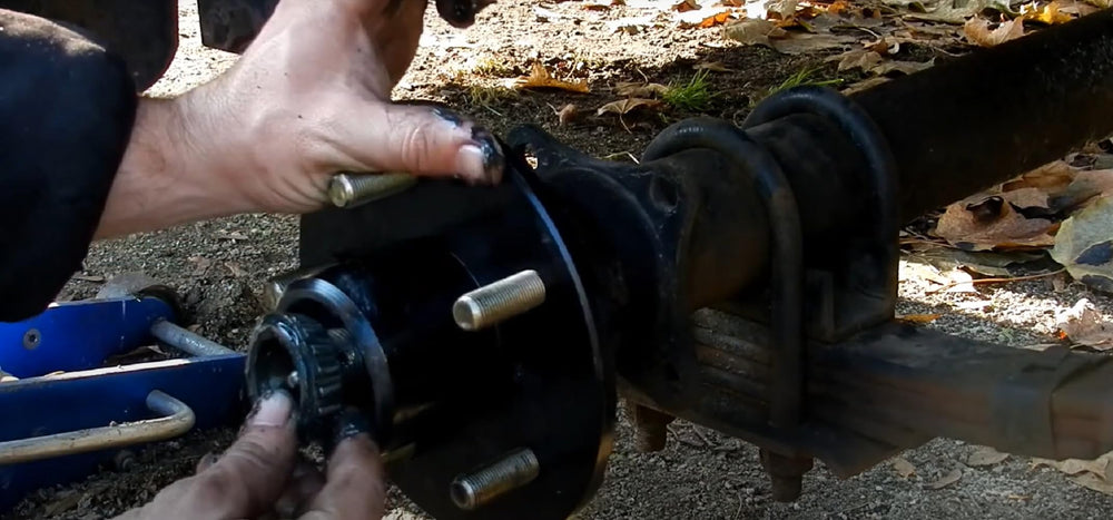 Lwlusup mechanic installing bearings on trailer hub showing reliable on-road readiness