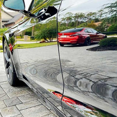 MAXL bottle spraying onto car door panel demonstrating fast application benefit