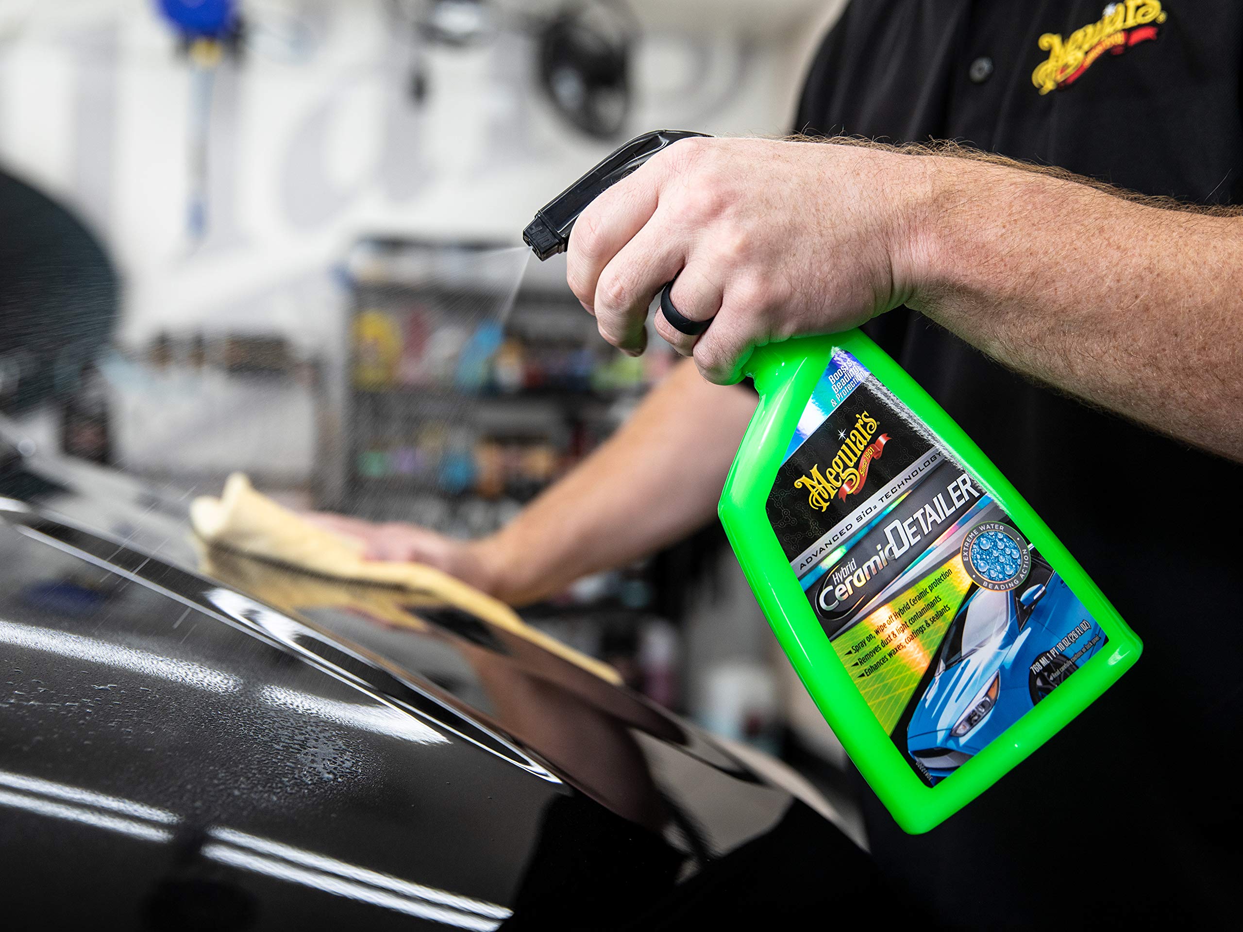 Meguiar's microfiber wiping applied detailer delivering streak-free finish