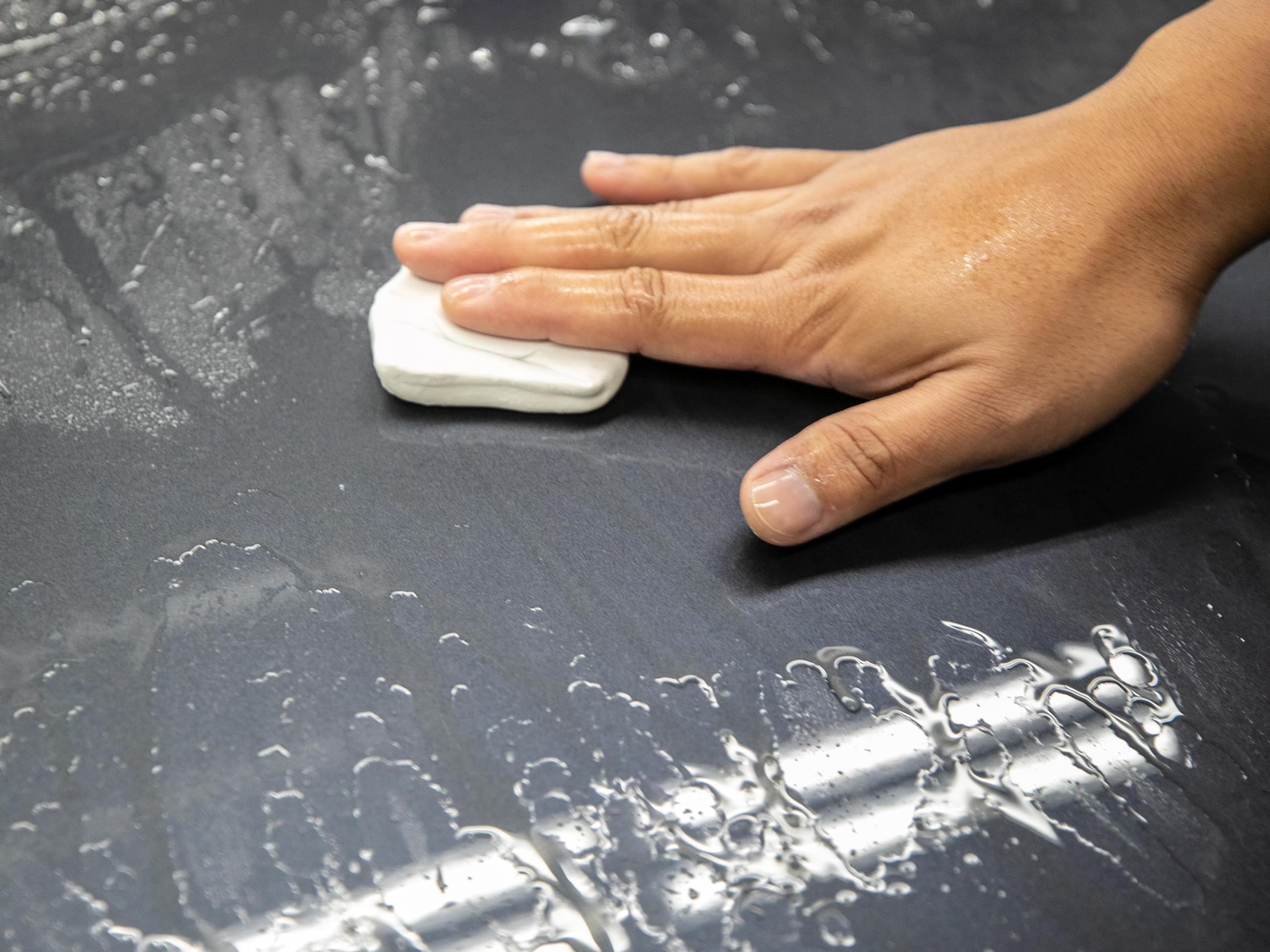 Meguiar's towel wiping gloss finish to remove clay residue and enhance shine