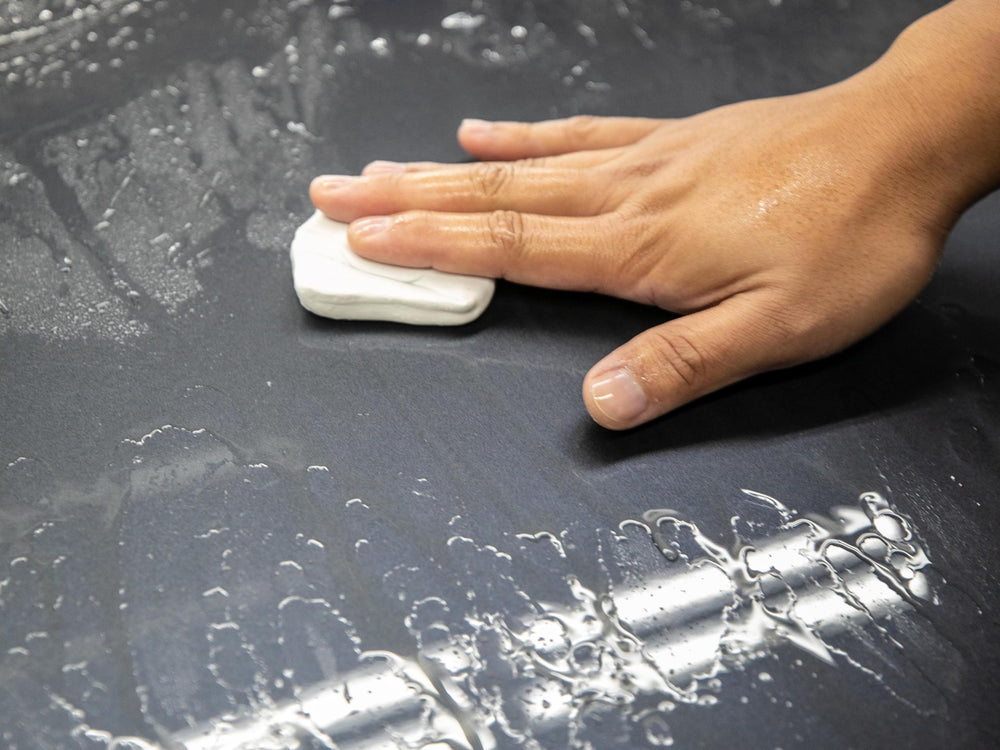 Meguiar's towel wiping gloss finish to remove clay residue and enhance shine