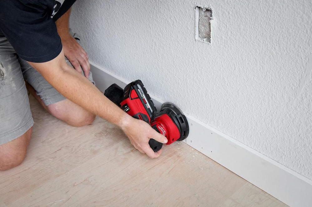 Milwaukee M18 FUEL sander in use on hardwood showing fast material removal