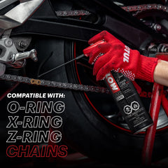 Motul C2 being sprayed on a motorcycle chain to improve lubrication and reduce wear
