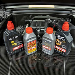 Motul bottle pouring into brake reservoir demonstrating clean transfer and easy refills