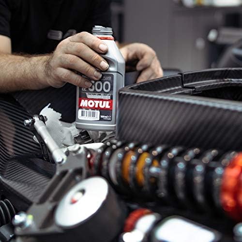 Motul 500ml bottle beside ruler showing exact volume for bleed and maintenance planning