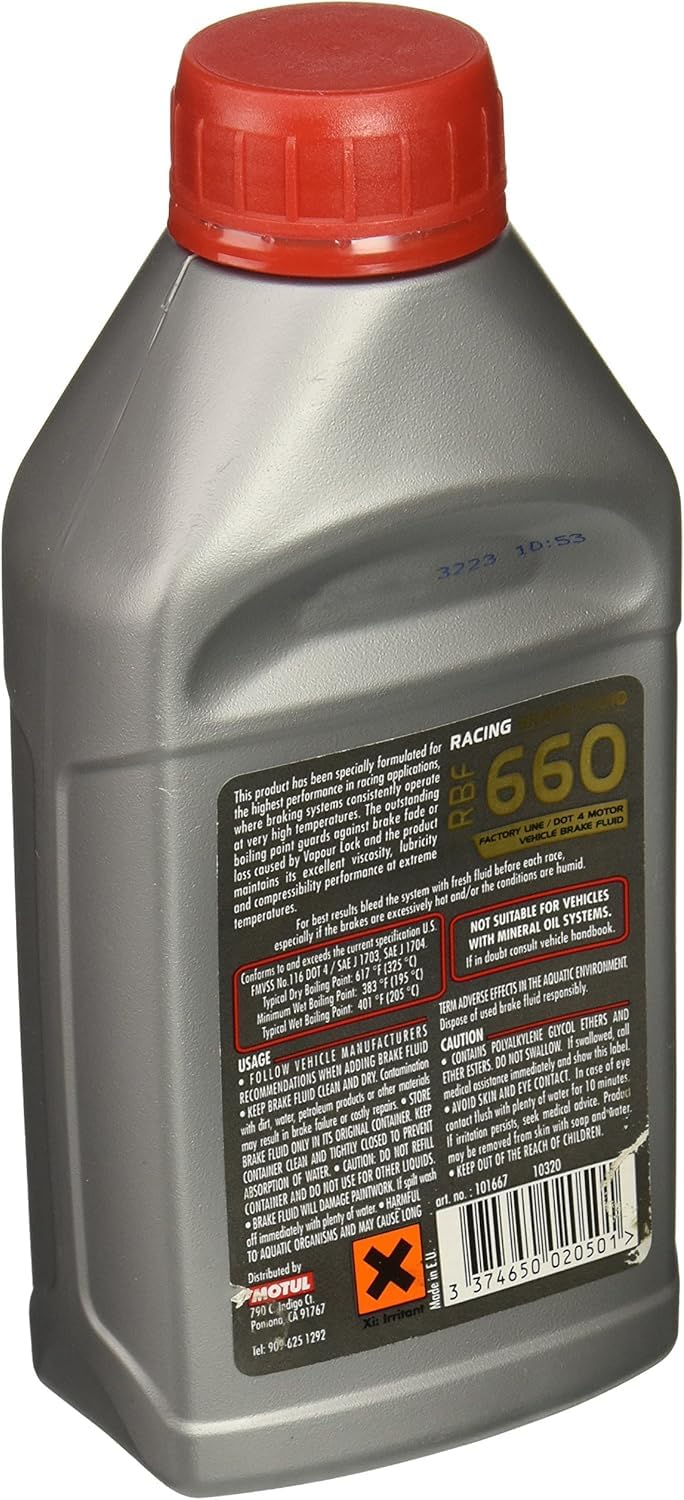 Motul pouring close-up into brake reservoir, demonstrating clean application and thermal stability