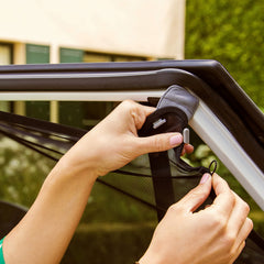 Munchkin Brica fully stretched across a window showing adaptable coverage
