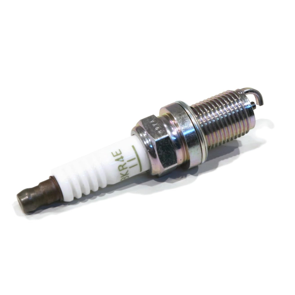 NGK four plugs neatly arranged to show quantity and replacement convenience