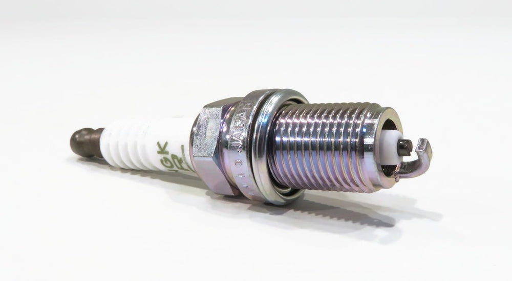 NGK spark plug in hand illustrating size and easy handling for DIYers