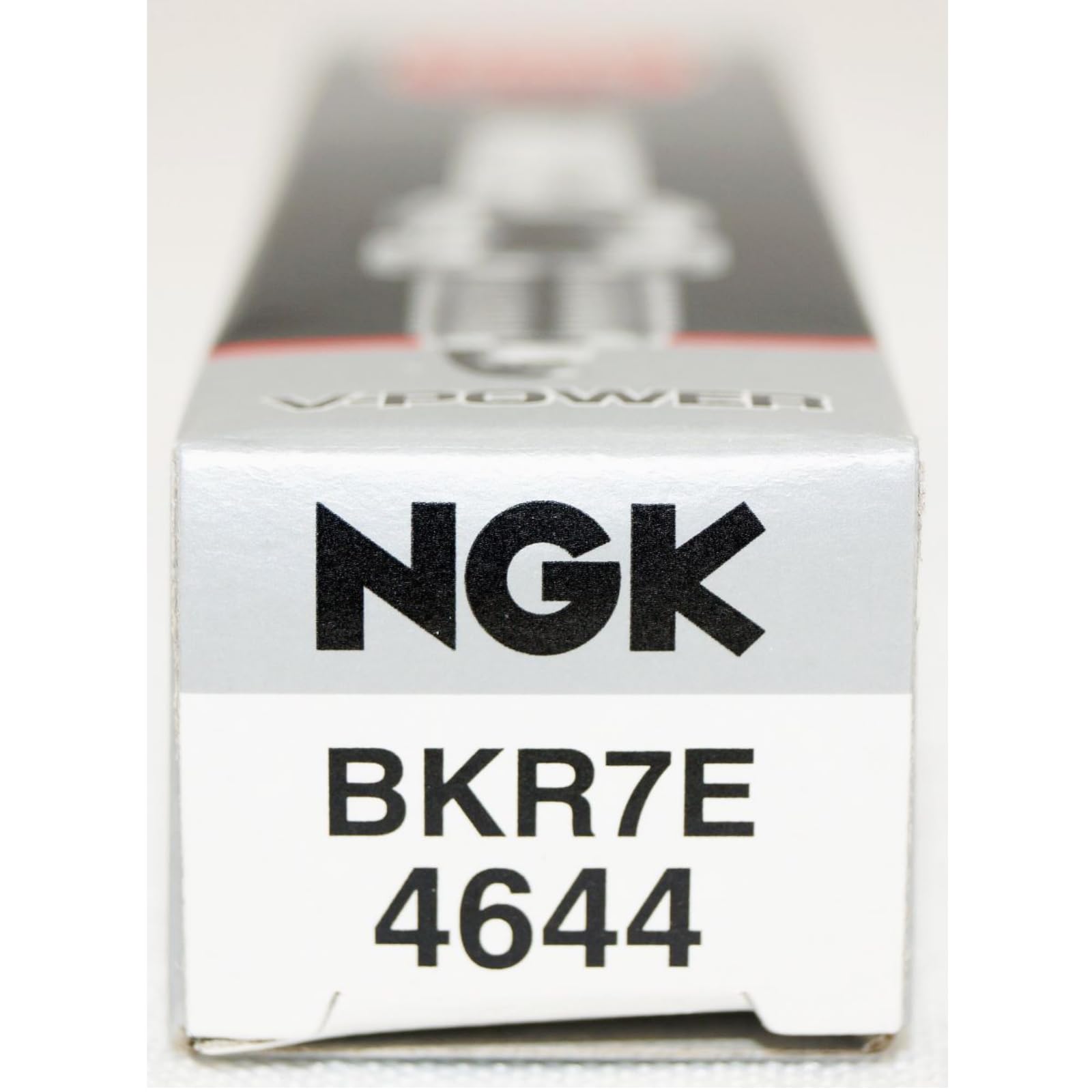 NGK spark plugs next to hand tools showing ease of installation and service convenience
