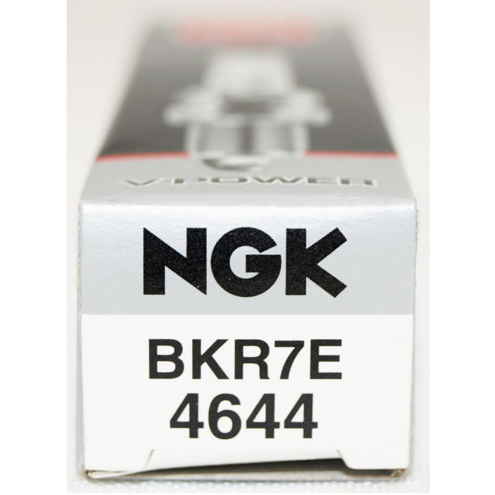 NGK spark plugs next to hand tools showing ease of installation and service convenience