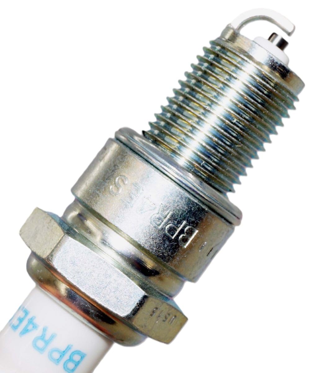 NGK spark plug beside ruler to show size and correct fitment verification