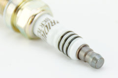 NGK iridium center electrode close-up showing precise spark focus