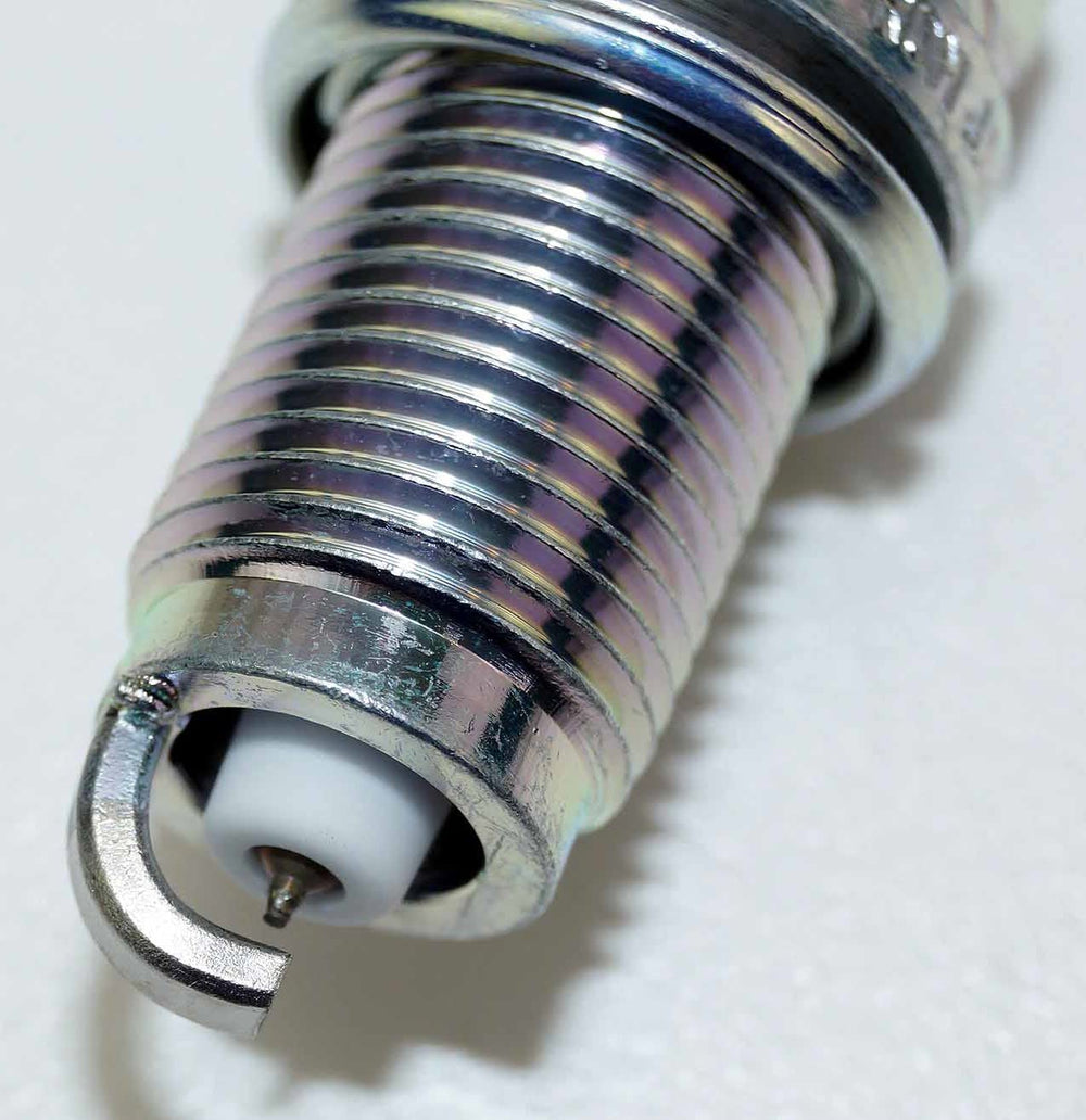 NGK spark plugs installed under hood demonstrating reliable ignition benefit
