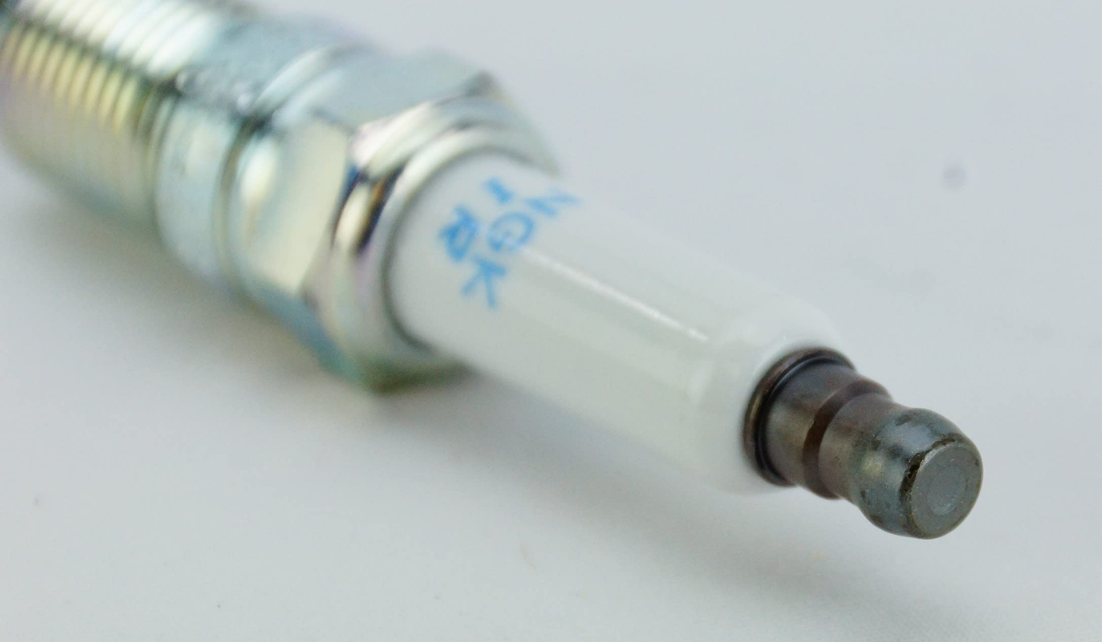 Handheld NGK IZTR5B11 plug to show scale and ease of handling during installation