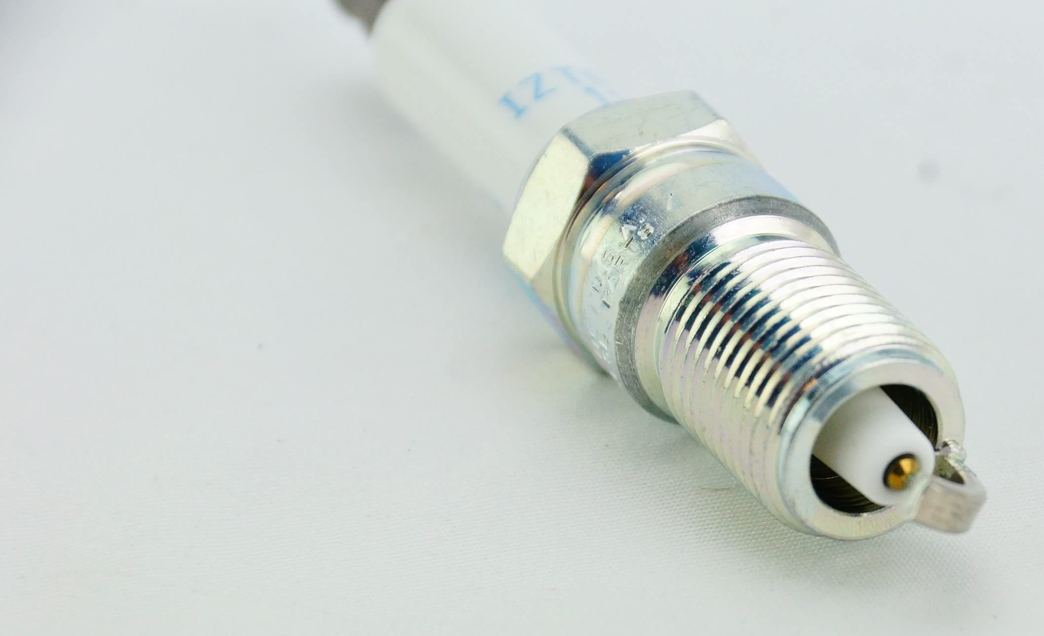 Open NGK pack revealing all eight IZTR5B11 plugs for full-cylinder replacement convenience