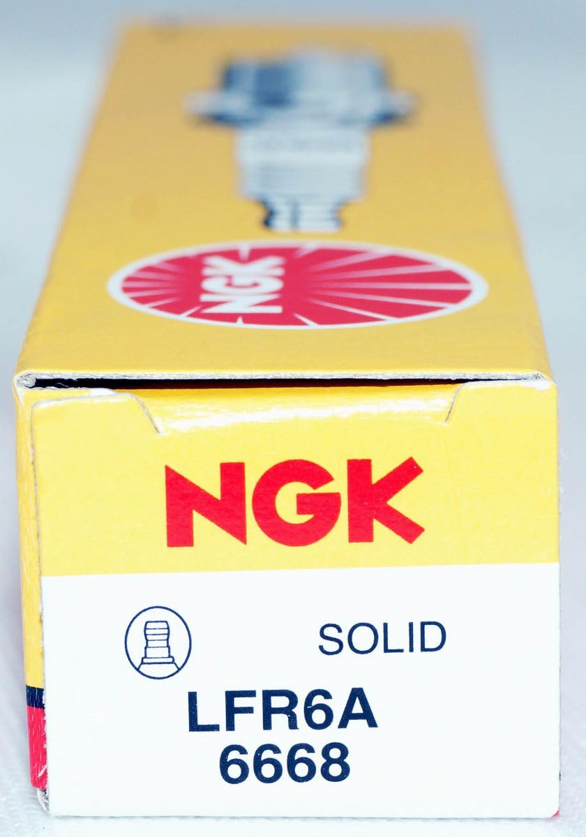 NGK LFR6A on a garage workbench conveying readiness for DIY maintenance