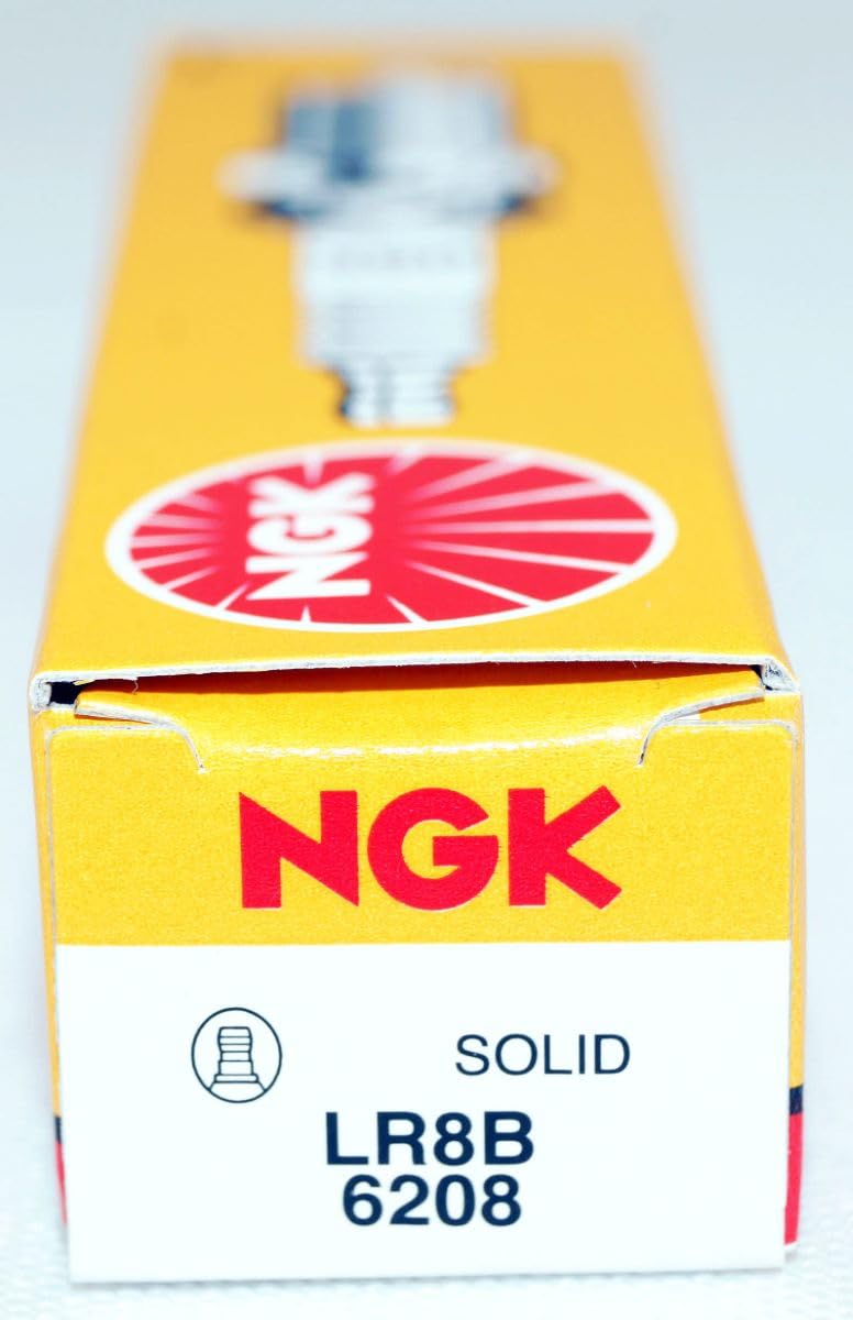 NGK LR8B on a workbench with tools illustrating practical maintenance readiness