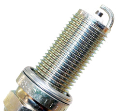 Hand holding NGK plug illustrating scale and straightforward handling