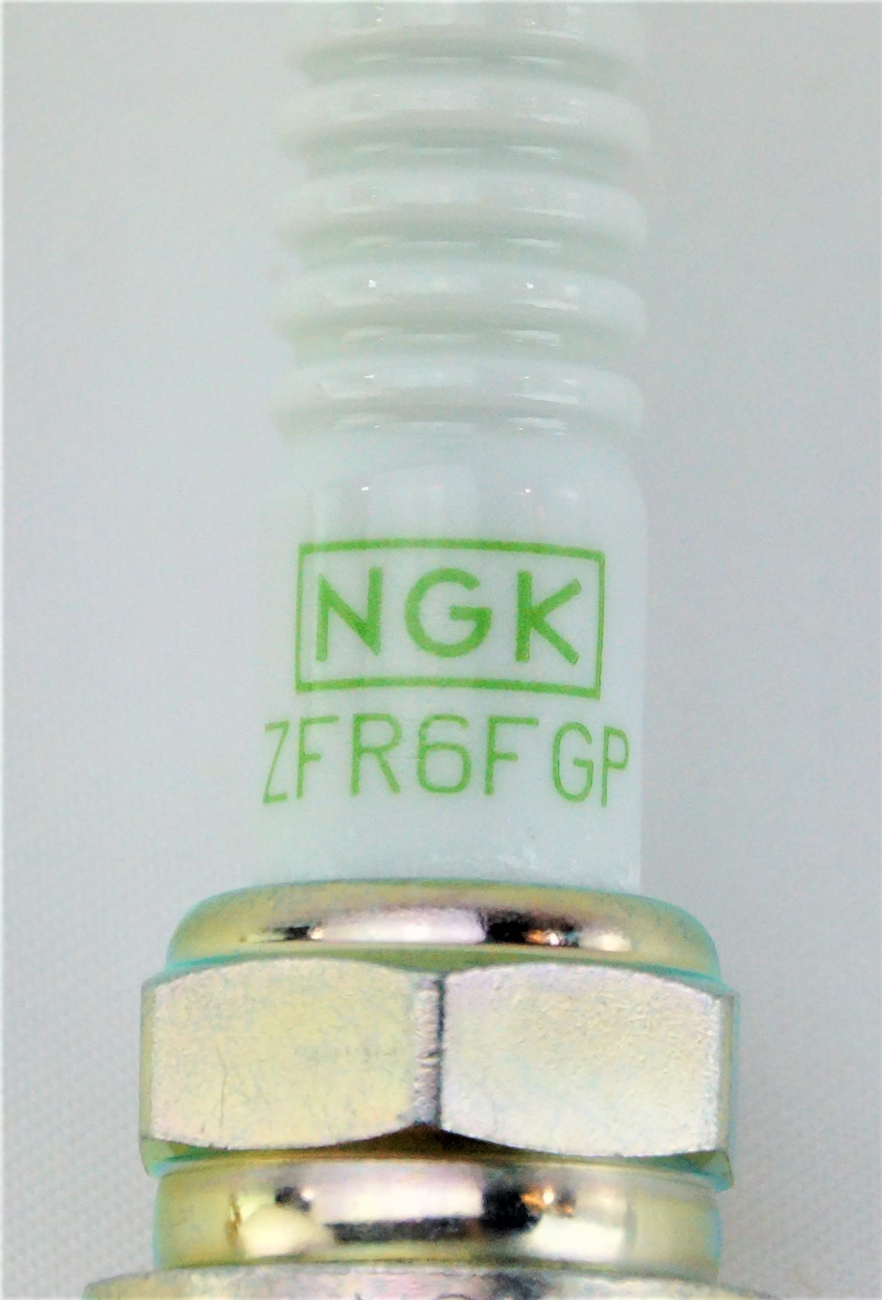NGK spark plug installed in engine demonstrating restored ignition fitment