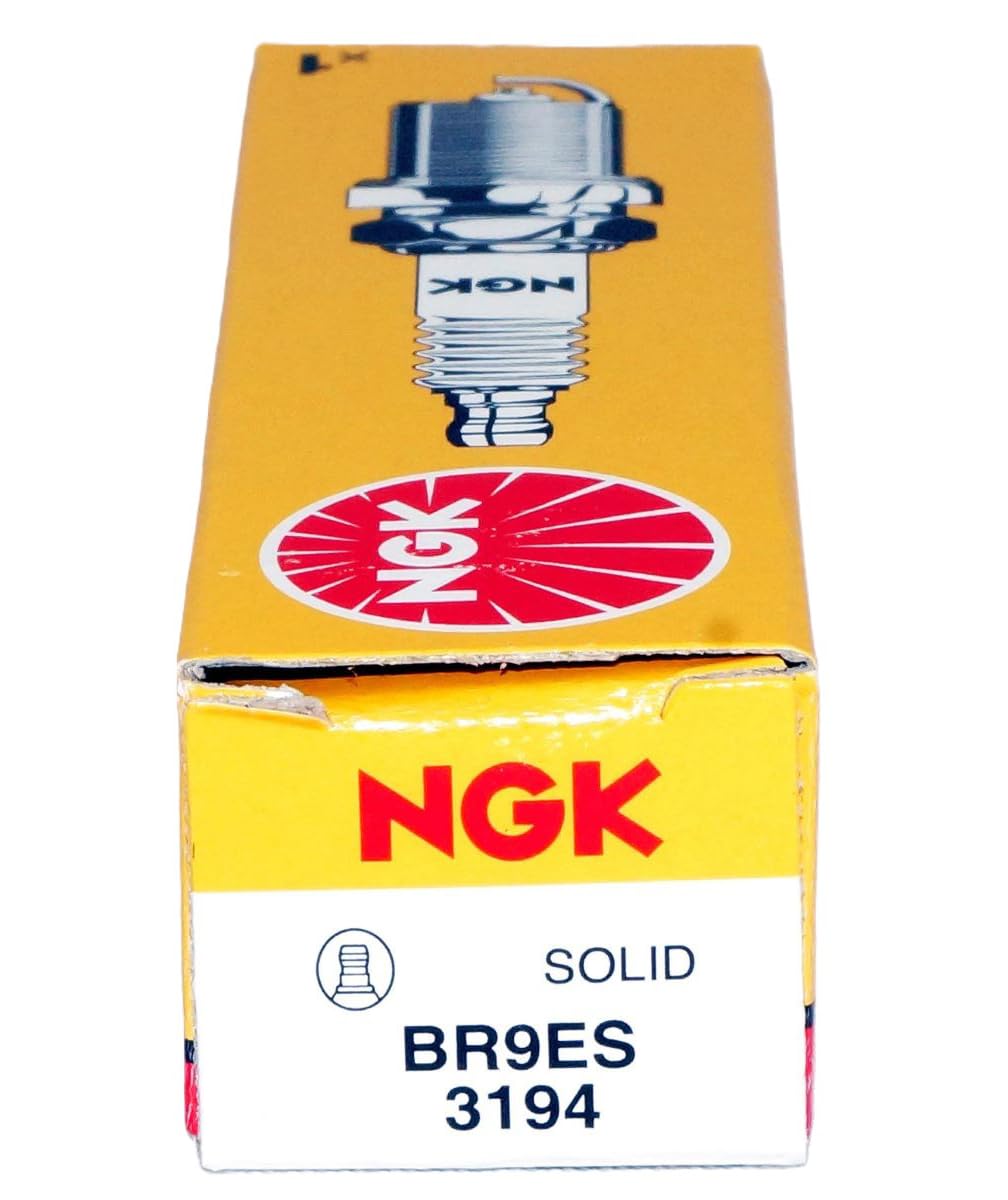 NGK spark plug next to a coin demonstrating compact size and compatibility