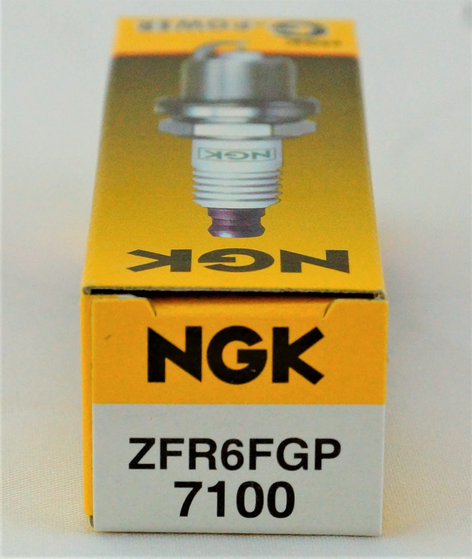 NGK spark plug beside ruler showing size and reach for correct selection