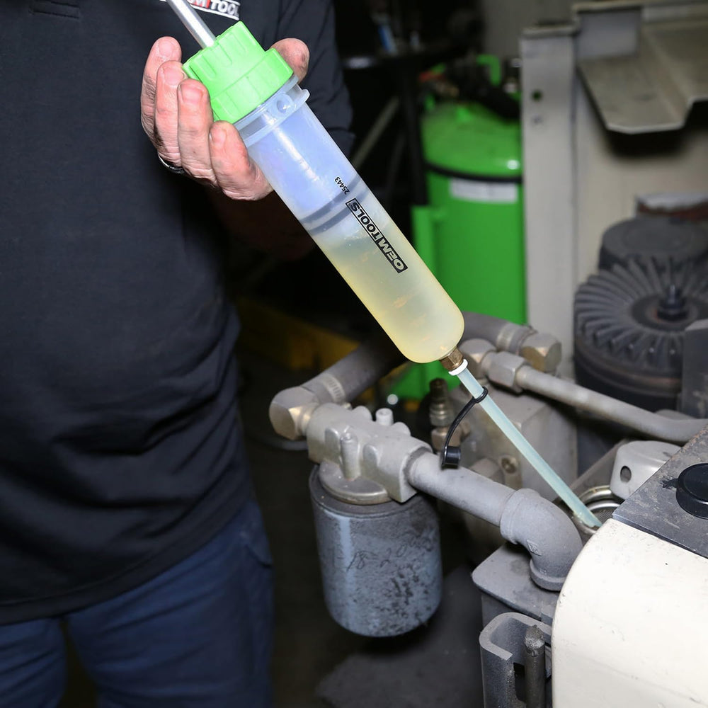 OEMTOOLS pump pictured next to hand to show compact 500 mL capacity and convenient scale