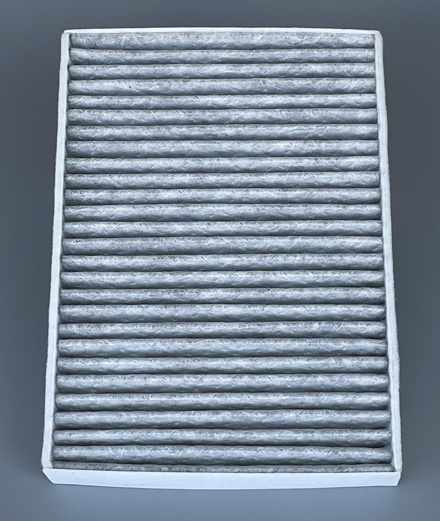 OIFILLIO filter next to coin for scale showing compact, OE fit