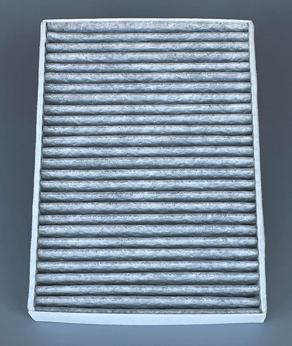 OIFILLIO filter next to coin for scale showing compact, OE fit