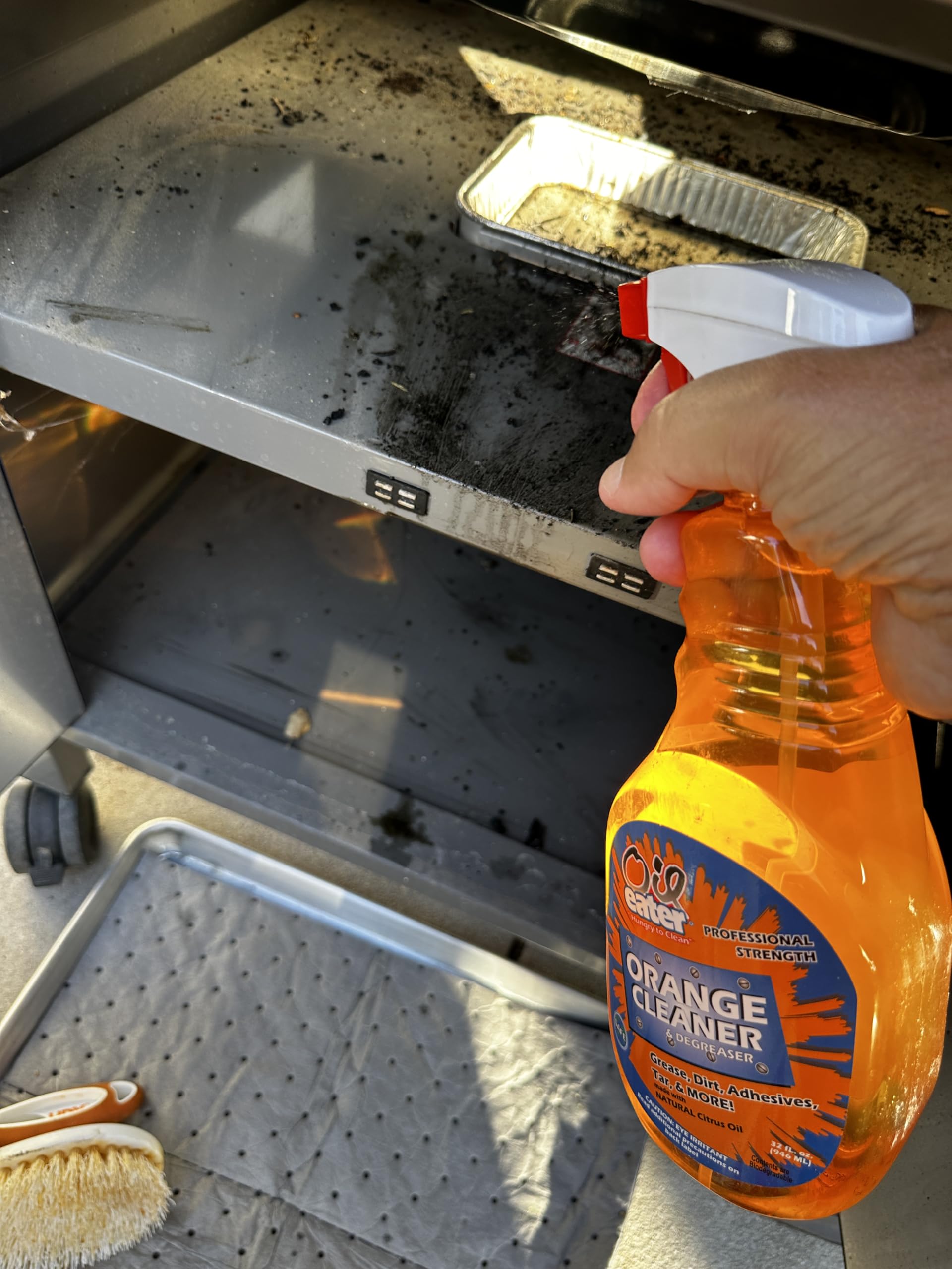 Oil Eater 32oz bottle next to a tape measure showing size and portability