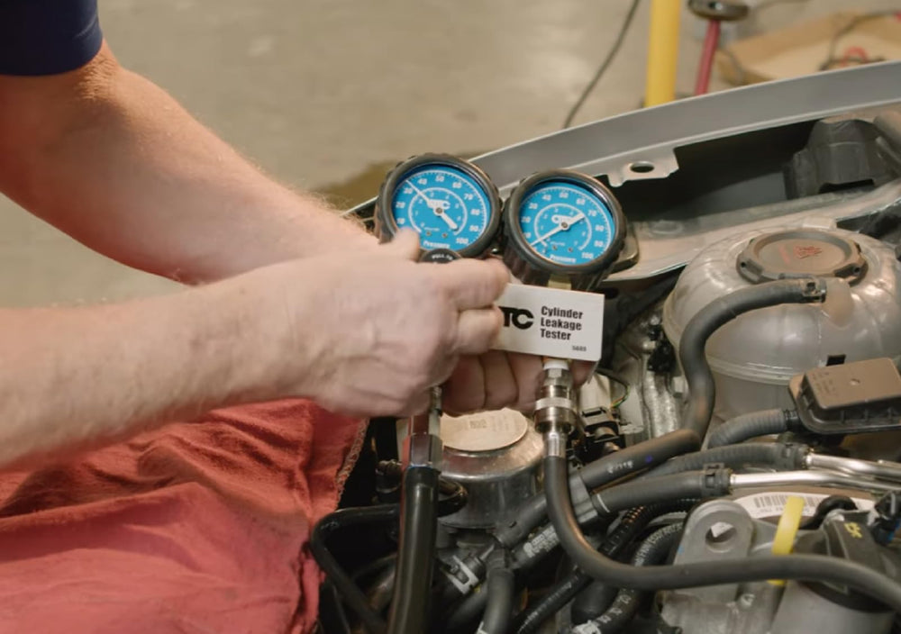 OTC 5609 hose connection detail showing secure coupling for leak-free tests