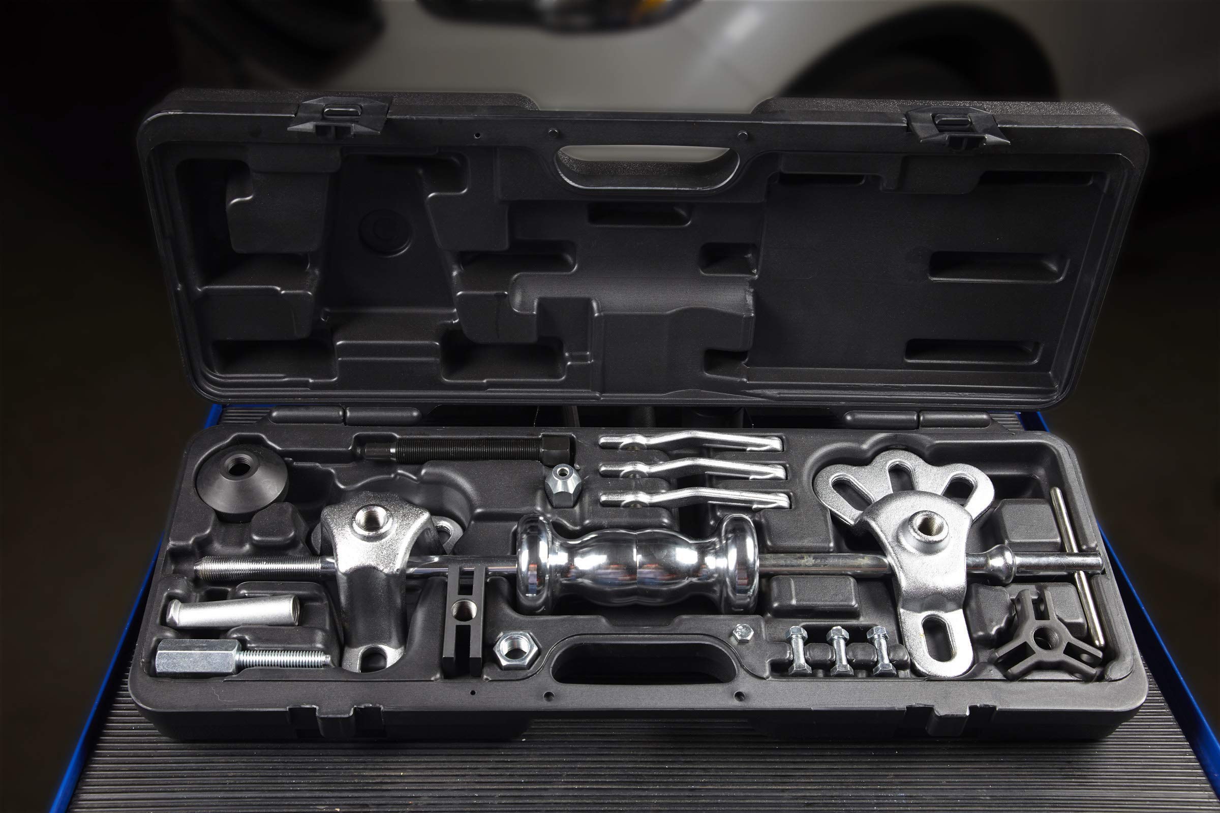 OTC dent puller attached to sheet metal illustrating non-destructive pulling