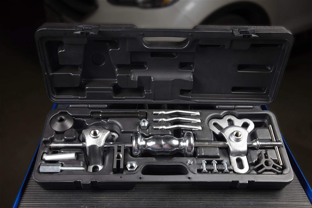OTC dent puller attached to sheet metal illustrating non-destructive pulling