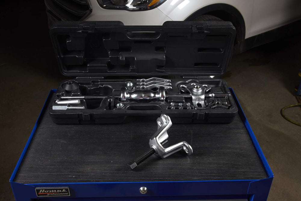 OTC rear axle puller shown attached to a flange-type axle for removal