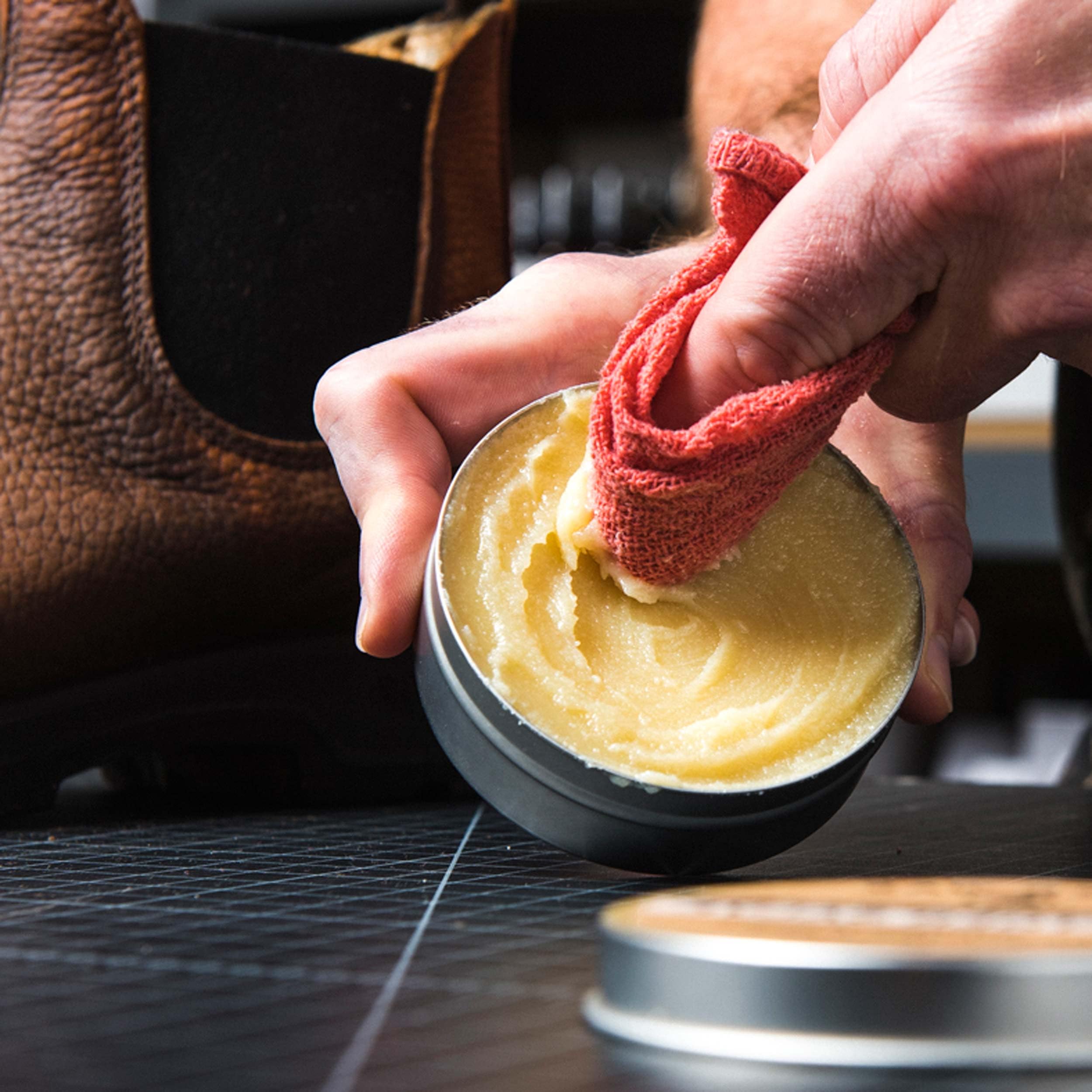 Otter Wax being applied to a leather boot to restore suppleness and protection