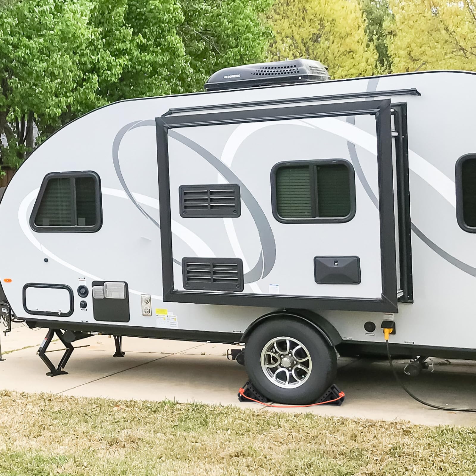OULEME chock on campsite showing weatherproof outdoor reliability benefit