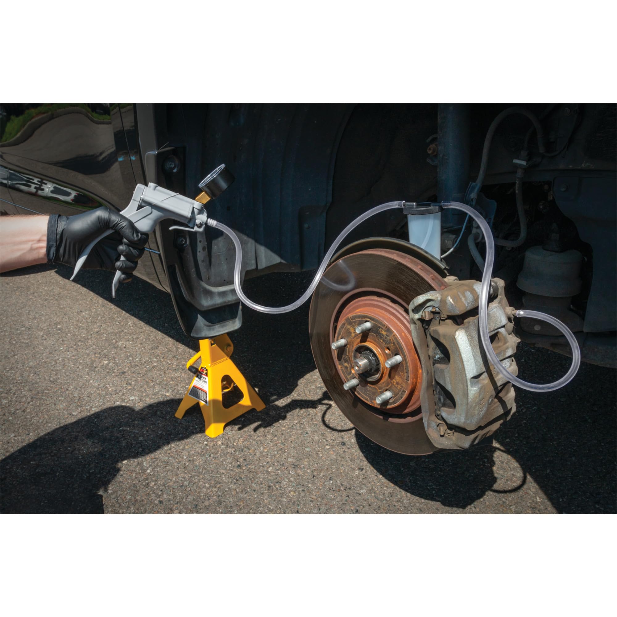 Performance Tool pump in use on vehicle demonstrating brake bleeding and diagnostic utility
