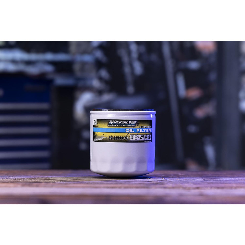 Quicksilver oil filter next to a coin for scale showing compact durable size