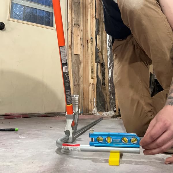 Rack-A-Tiers Kick Wedge placed under a 90-degree conduit elbow demonstrating accurate alignment