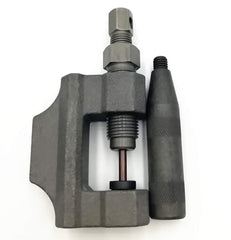 RepairWill chain breaker pressing a rivet on a motorcycle chain for accurate removal