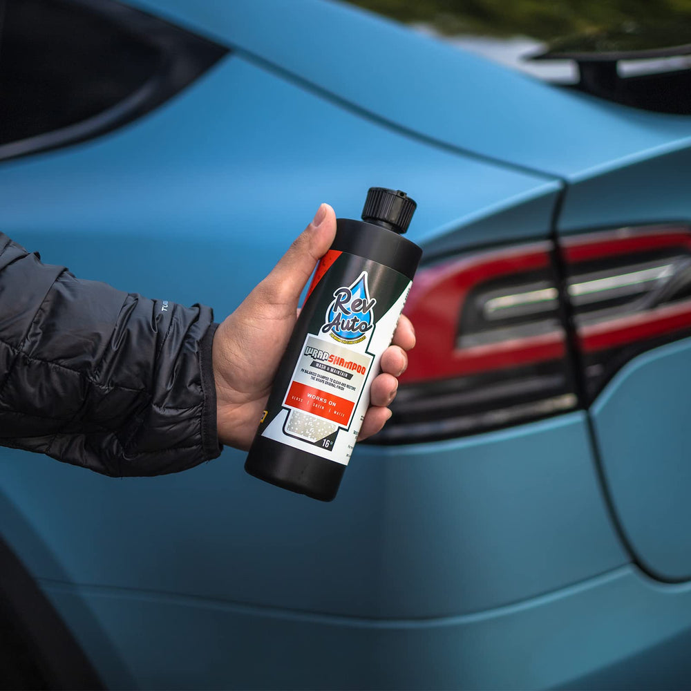 Rev Auto shampoo cleaning a wrapped vehicle in driveway preserving finish appearance