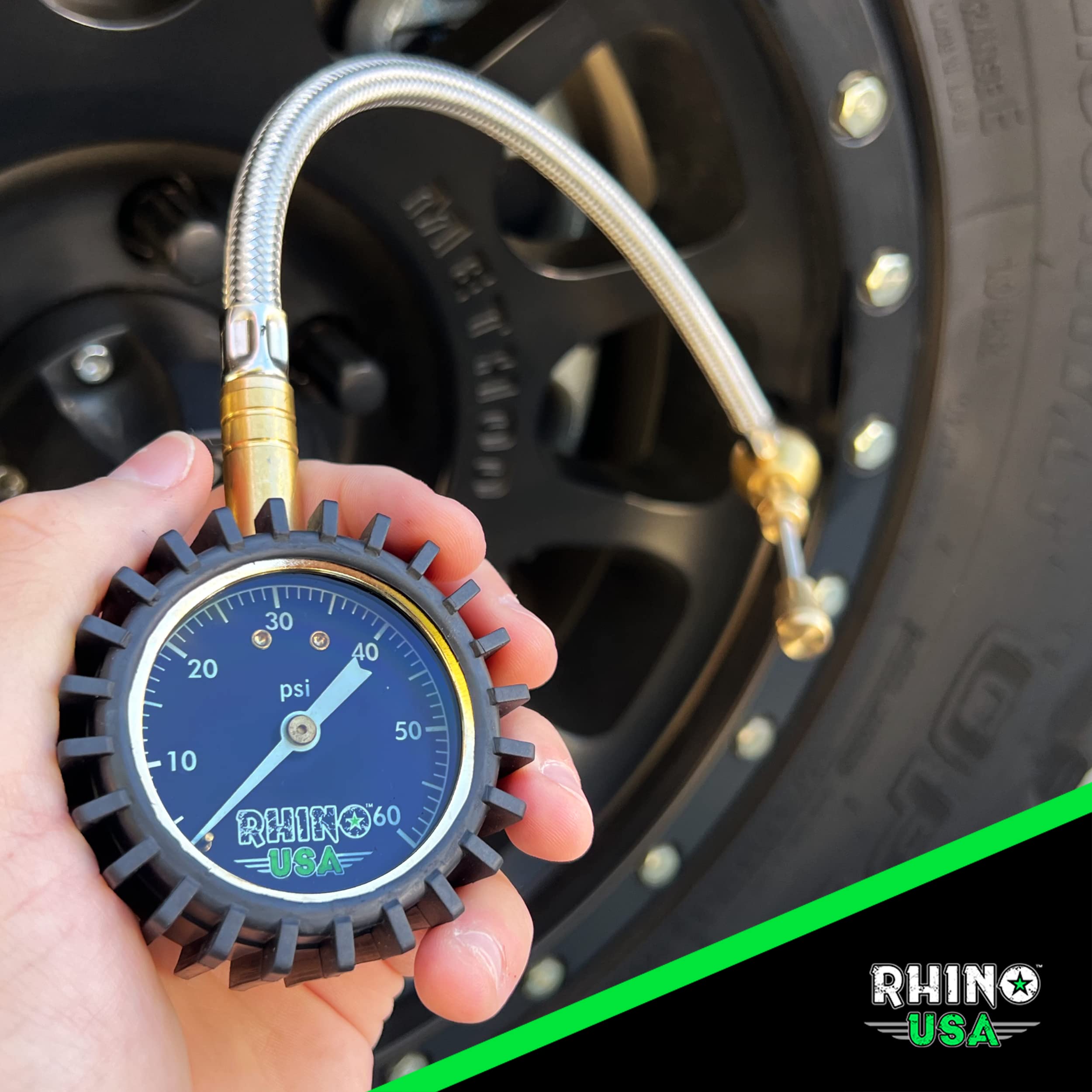 Rhino USA deflator attached to Jeep tire during airing down, speeds setup and monitoring on trail