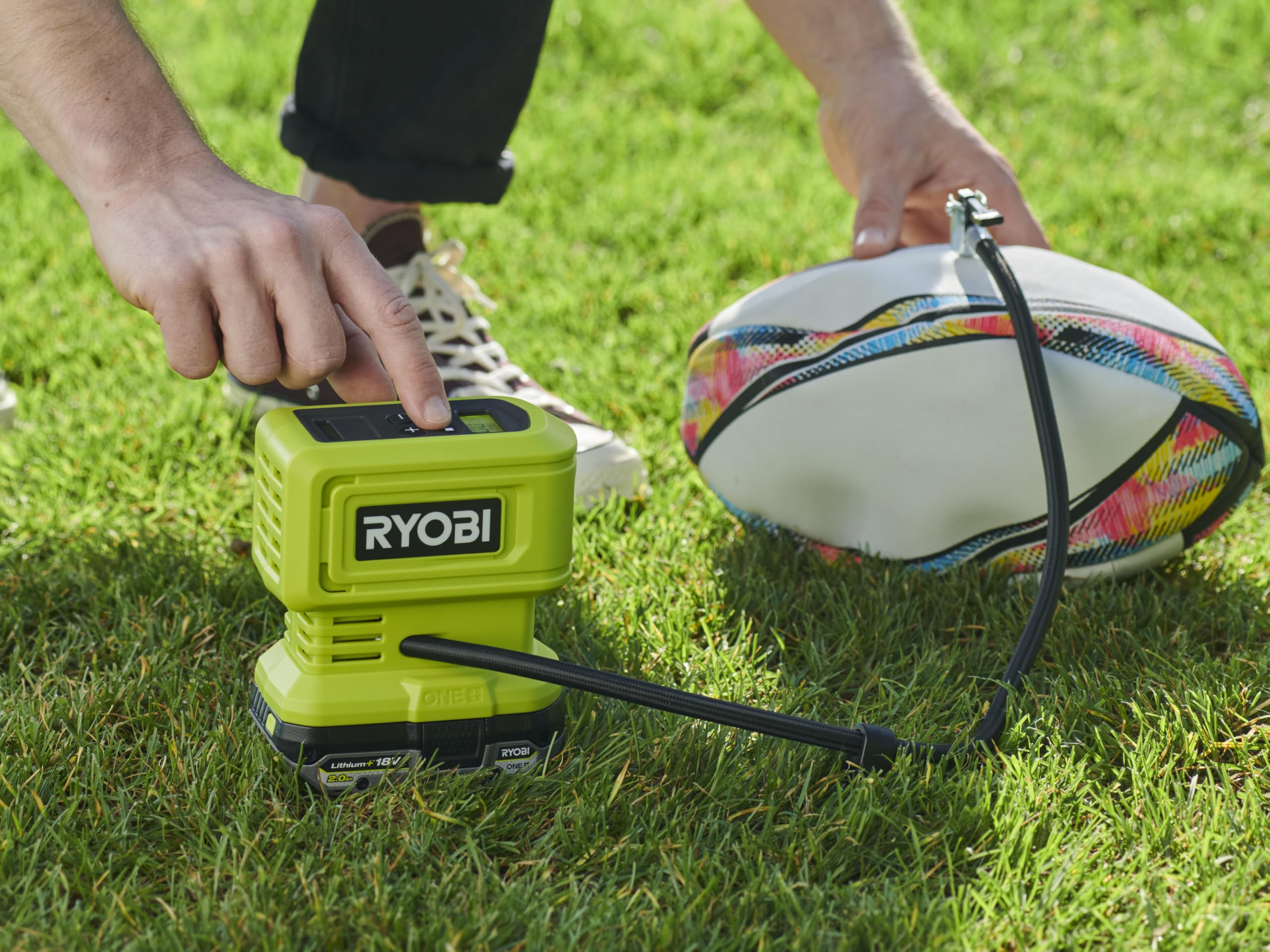RYOBI RPI18 handheld next to a hand showing compact size and control