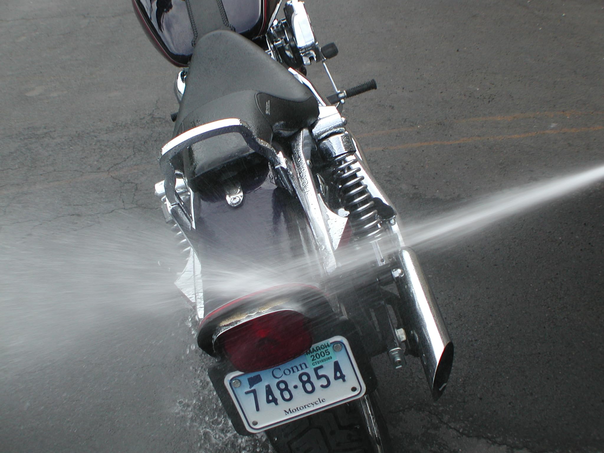 S S100 cleaner being sprayed on motorcycle for fast dirt removal benefit