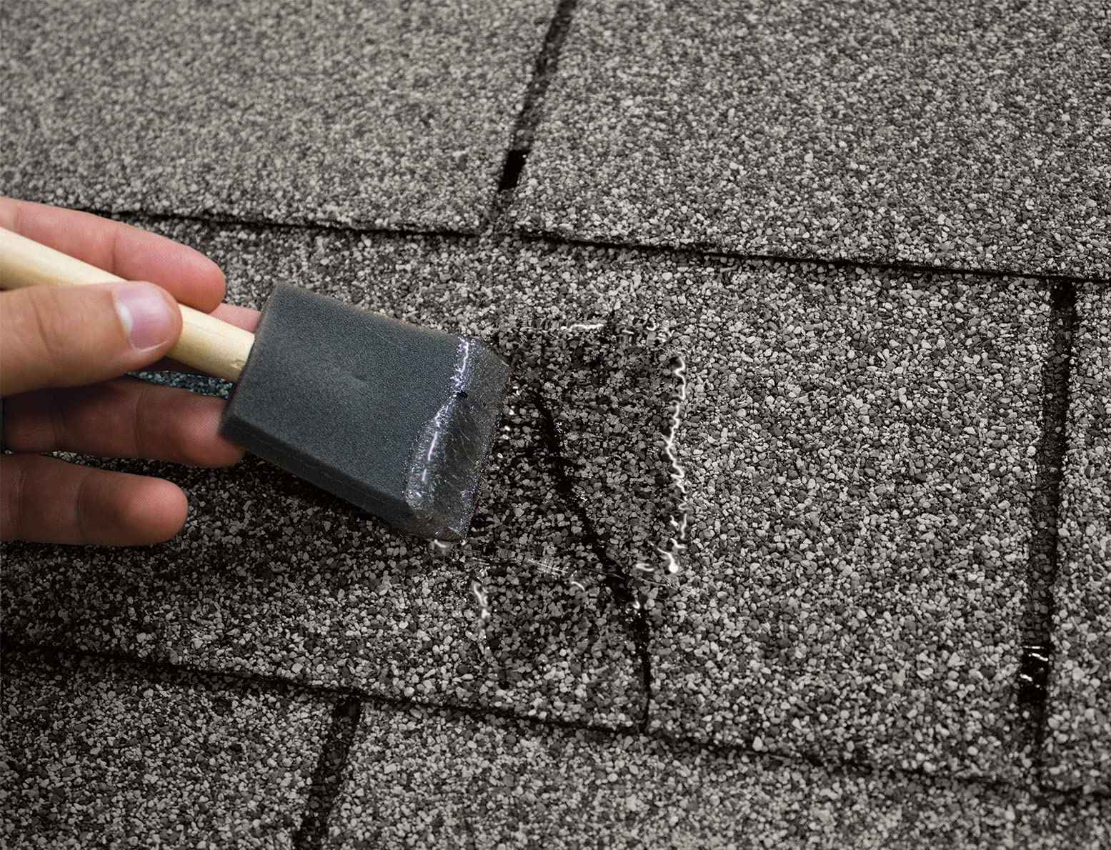 Sashco in-use close-up sealing roof flashing with clear, flexible finish